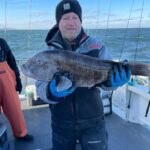 a person holding a fish in the water