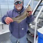 a person holding a fish in the water