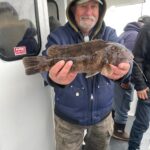 a man holding a fish