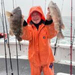 a man holding a fish