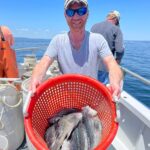 a man sitting on a boat in the water