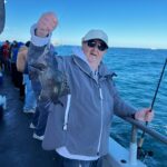 a man holding a fish in the water