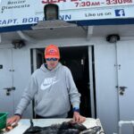 a man cutting a cake