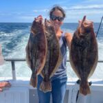 a person holding a fish in the water