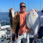 a man holding a fish on a boat