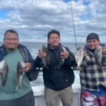 a couple of people standing next to a body of water