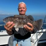 a man holding a fish