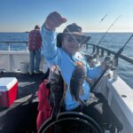 a person holding a fish on a boat