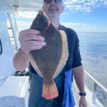 a man holding a fish