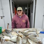 a man holding a fish