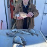 a man holding a fish