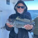 a person holding a fish in the water