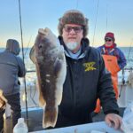 a man holding a fish