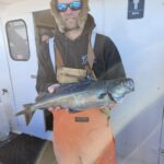 a person holding a fish