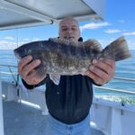 a person holding a fish in the water