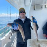 a person holding a fish on a boat