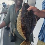 a person holding a fish