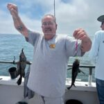 a person holding a fish in the water
