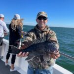 a man holding a fish