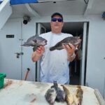 a man holding a fish