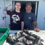a man holding a fish