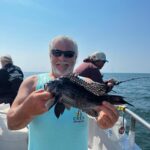a man holding a fish in the water