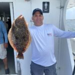 a man holding a fish