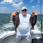 a person holding a fish on a boat
